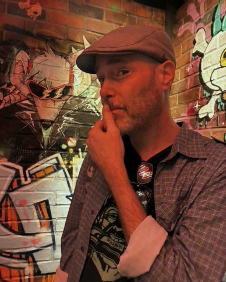 Jake Standley in front of a wall of character work