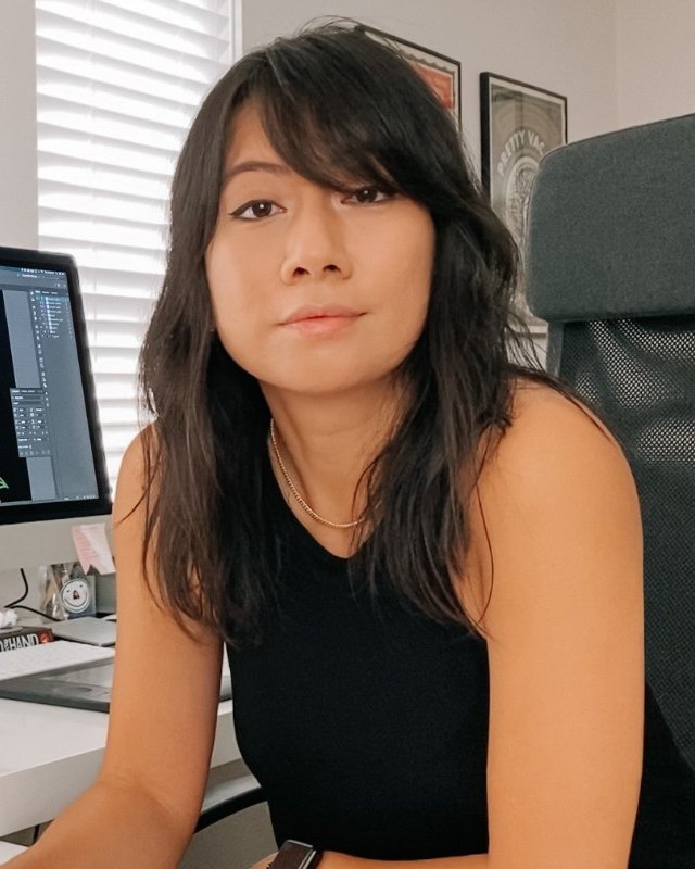Joanna Munoz at her desk with lettering work on screen